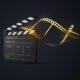 film-clapperboard-with-curled-golden-filmstrip_305440-22