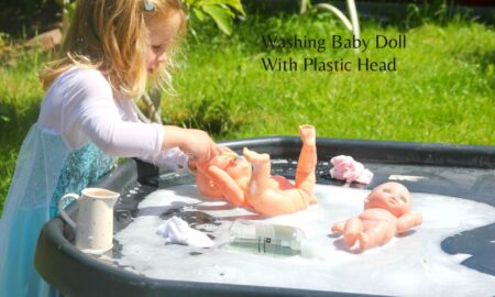 washing baby doll with plastic head